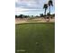 Scenic view of a golf course featuring a well-manicured green and a sand trap at 15881 W Berkeley Rd, Goodyear, AZ 85395