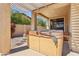 Covered patio with a hot tub and decorative stone columns at 15881 W Berkeley Rd, Goodyear, AZ 85395