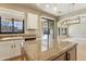 Kitchen island showcases granite counters, stainless steel appliances, and backyard access at 15881 W Berkeley Rd, Goodyear, AZ 85395