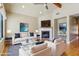 Cozy living room with fireplace, ceiling fan and comfortable seating at 15881 W Berkeley Rd, Goodyear, AZ 85395