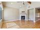 Spacious living room featuring hardwood floors, fireplace, and large windows at 15881 W Berkeley Rd, Goodyear, AZ 85395