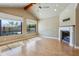 Bright living room with hardwood floors, a fireplace, and views of the pool at 15881 W Berkeley Rd, Goodyear, AZ 85395