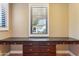 Desk with storage in a home office with windows featuring plantation shutters at 15881 W Berkeley Rd, Goodyear, AZ 85395