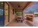 Covered patio featuring an outdoor kitchen, dining area, and access to the backyard at 15881 W Berkeley Rd, Goodyear, AZ 85395