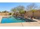 Beautiful backyard pool with stone pillar features and well manicured landscaping at 15881 W Berkeley Rd, Goodyear, AZ 85395