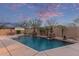 Backyard pool with stone pillars and a beautiful sunset at 15881 W Berkeley Rd, Goodyear, AZ 85395