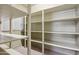 Storage room with several shelves, carpeted floor, and window at 15881 W Berkeley Rd, Goodyear, AZ 85395