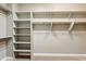 This closet features built-in shelving and hanging rods, offering ample storage and organization options at 15881 W Berkeley Rd, Goodyear, AZ 85395