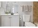 Cozy bathroom with vanity, toilet, mirror, and towel rack at 1747 W Belfast St, Mesa, AZ 85201