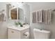 Bathroom featuring vanity, toilet, mirror, and towel rack at 1747 W Belfast St, Mesa, AZ 85201