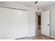 Bedroom featuring a closet and ensuite bathroom access and wood-look floors at 1747 W Belfast St, Mesa, AZ 85201