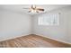 Bright bedroom featuring wood-look floors, a ceiling fan, and a window with blinds at 1747 W Belfast St, Mesa, AZ 85201