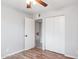 Bedroom featuring a closet and ensuite bathroom access and wood-look floors at 1747 W Belfast St, Mesa, AZ 85201