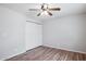 Bedroom with wood-look flooring, closet, and ceiling fan at 1747 W Belfast St, Mesa, AZ 85201