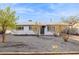 Charming single-story home with grey facade, dark gravel yard, and minimal landscaping at 1747 W Belfast St, Mesa, AZ 85201