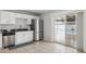 Kitchen featuring white cabinets, stainless steel appliances, and a pass-through to the back patio at 1747 W Belfast St, Mesa, AZ 85201