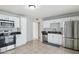 Bright kitchen with white cabinets, stainless steel appliances, and tile flooring at 1747 W Belfast St, Mesa, AZ 85201