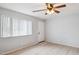 Living room featuring tiled floors, neutral walls, and a ceiling fan at 1747 W Belfast St, Mesa, AZ 85201