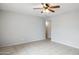 Open living room with neutral walls, tile floors, and ceiling fan at 1747 W Belfast St, Mesa, AZ 85201