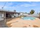 A backyard pool and concrete patio with a covered patio and washer and dryer at 1747 W Belfast St, Mesa, AZ 85201