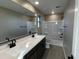 Bathroom featuring double vanity, framed mirror, bathtub and shower at 17541 W Lupine Ave, Goodyear, AZ 85338