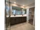 This bathroom showcases a double sink vanity, a large mirror, and a walk-in shower, creating a spa-like feel at 17541 W Lupine Ave, Goodyear, AZ 85338