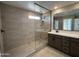 Modern bathroom features a sleek glass-enclosed shower and stylish vanity with quartz countertop at 17541 W Lupine Ave, Goodyear, AZ 85338