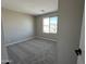 Cozy carpeted bedroom with a large window offers comfort and natural light, perfect for relaxation at 17541 W Lupine Ave, Goodyear, AZ 85338