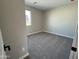 Cozy bedroom featuring carpet flooring, neutral paint, and a window providing natural light at 17541 W Lupine Ave, Goodyear, AZ 85338