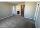 This carpeted bedroom features neutral walls and leads to an ensuite bathroom for added convenience at 17541 W Lupine Ave, Goodyear, AZ 85338