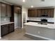 Well-equipped kitchen featuring granite countertops, stainless steel appliances, and ample cabinet space at 17541 W Lupine Ave, Goodyear, AZ 85338