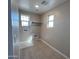 Well-lit laundry room with tile flooring, utility sink, and hookups for washer and dryer for convenience at 17541 W Lupine Ave, Goodyear, AZ 85338