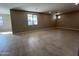 Spacious living room with tile flooring, recessed lighting, and large windows allowing natural light at 17541 W Lupine Ave, Goodyear, AZ 85338