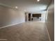 Open-concept living area with tile flooring, seamlessly connected to the kitchen with bar seating at 17541 W Lupine Ave, Goodyear, AZ 85338