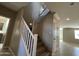 Carpeted staircase with white banister leading to the second floor of the home at 17541 W Lupine Ave, Goodyear, AZ 85338