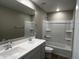 Bathroom with double sinks, large mirror and bathtub-shower combination at 17558 W Lupine Ave, Goodyear, AZ 85338