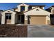 Inviting two-story home featuring a tan stucco exterior, brown tile roof, and a spacious two-car garage at 17558 W Lupine Ave, Goodyear, AZ 85338