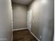 A hallway with tile floors and two white doors at 17558 W Lupine Ave, Goodyear, AZ 85338