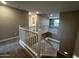 Carpeted staircase with white railings leading to the upper level of the home at 17558 W Lupine Ave, Goodyear, AZ 85338