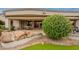 Backyard view with putting green, rock features, and an inviting covered patio area at 17642 N Ironhorse Dr, Surprise, AZ 85374