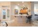 Cozy bar area featuring wooden cabinets, mirrored backsplash, and counter seating at 17642 N Ironhorse Dr, Surprise, AZ 85374