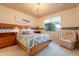 Bedroom with a large bed, chandelier lighting, a window with blinds, and light-colored walls at 17642 N Ironhorse Dr, Surprise, AZ 85374