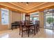 Elegant dining area with seating for six, display cabinet and views of the lush landscape at 17642 N Ironhorse Dr, Surprise, AZ 85374