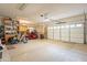 Spacious garage featuring a red golf cart, bike, and two white garage doors at 17642 N Ironhorse Dr, Surprise, AZ 85374