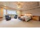 Bright main bedroom featuring bay window with views, plush carpeting, and sitting area at 17642 N Ironhorse Dr, Surprise, AZ 85374