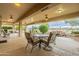 View of the covered patio with table, chairs, and backyard at 17642 N Ironhorse Dr, Surprise, AZ 85374