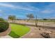 View of the backyard putting green with well-maintained landscaping and scenic surroundings at 17642 N Ironhorse Dr, Surprise, AZ 85374