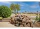 Inviting backyard with a custom rock waterfall feature adding a serene ambiance at 17642 N Ironhorse Dr, Surprise, AZ 85374