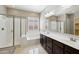 Bathroom showcasing a glass shower, soaking tub, and dual vanity sinks at 1800 N 156Th Dr, Goodyear, AZ 85395