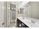 Well-lit bathroom features dual sinks, dark wood cabinetry and neutral wall color at 1800 N 156Th Dr, Goodyear, AZ 85395